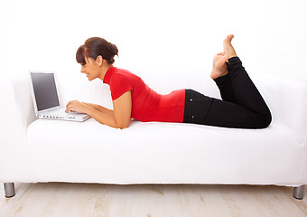 Image showing Girl with laptop on couch