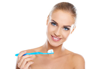 Image showing Closeup portrait of a woman brushing her teeth