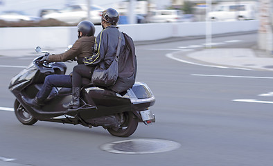 Image showing Friends riding a bike