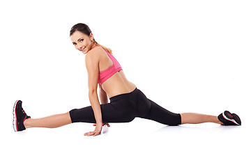 Image showing Pretty smiling woman doing the splits