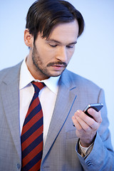Image showing Man reading a text message on his mobile