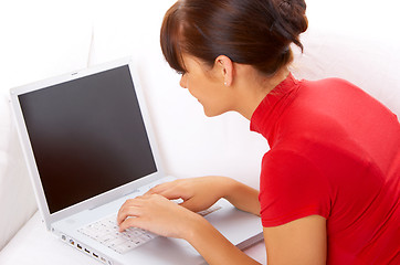 Image showing Girl with laptop on couch