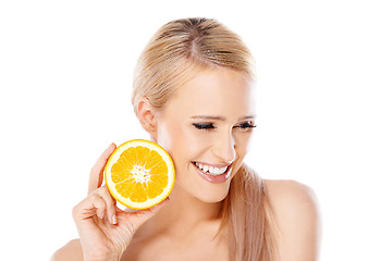 Image showing Blond woman with beautiful smile holding orange