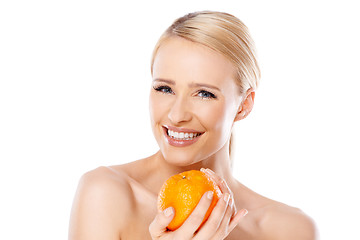 Image showing Smiling girl is holding fresh orange