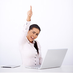 Image showing Happy woman sitting at her desk, with one arm rised