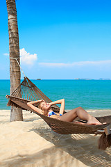 Image showing Woman enjoying the serenity of a tropical beach