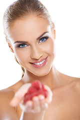 Image showing Close up of smiling blonde holding raspberries