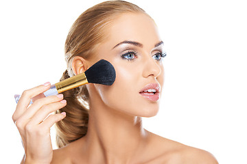 Image showing Beautiful woman applying blusher