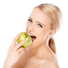 Image showing Beautiful girl is biting fresh apple