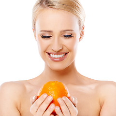 Image showing Smiling girl is holding fresh orange