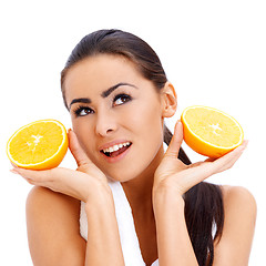 Image showing Woman with fresh orange halfs in her hands