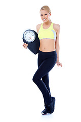 Image showing Full body of blond sporty woman holding scale