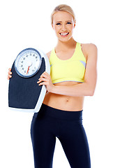 Image showing Smiling woman holding a waight scale