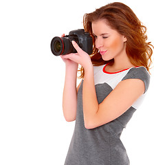 Image showing Woman in gray dress wit digtal camera on white