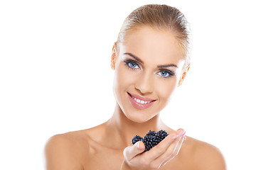 Image showing Smiling healthy woman with blackberries