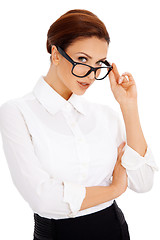 Image showing Woman peering over her glasses