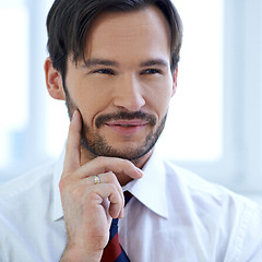 Image showing Smiling man lost in thought