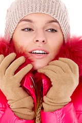 Image showing Young woman wearing winter jacket scarf and cap