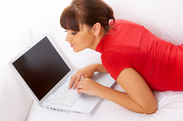 Image showing Girl with laptop on couch