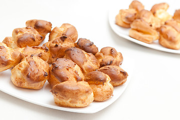 Image showing delisious profiteroles on the white plate