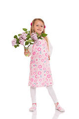 Image showing Smiling little girl with lilac flowers