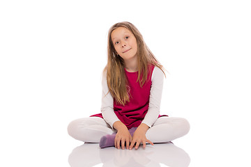 Image showing Young girl making faces on the floor