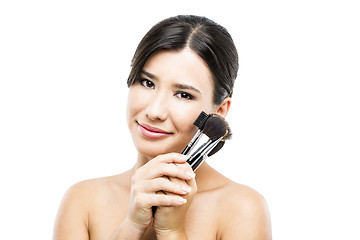 Image showing Beautiful Asian woman with make-up brushes