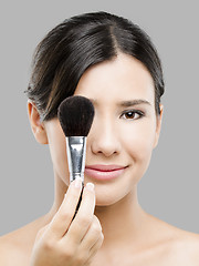 Image showing Beautiful Asian woman with make-up brushes