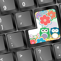 Image showing owl family and flowers on computer keyboard key