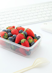 Image showing Berry mix lunch on working desk in office 