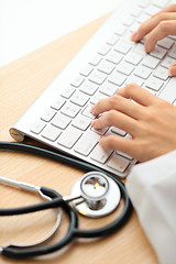 Image showing Doctor typing on keyboard with stethoscope