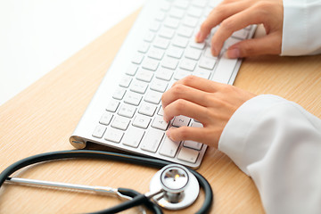 Image showing Doctor typing on keyboard with stethoscope