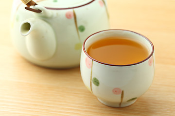 Image showing Cup of tea with teapot