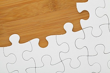 Image showing Puzzle on wooden board