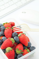 Image showing Healthy lunch with strawberry and blueberry mix in office