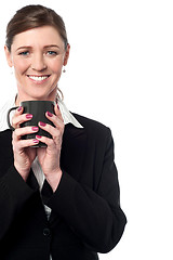 Image showing Pretty female manager enjoying her coffee