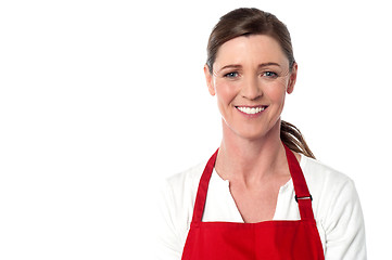 Image showing Attractive female chef wearing red apron