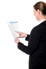 Image showing Back pose of businesswoman reading reports