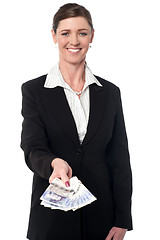 Image showing Smiling corporate woman showing british pounds