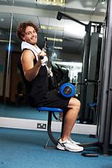 Image showing Man exercising with help of a hydraulic equipment