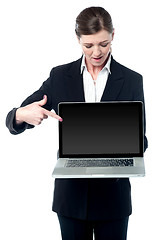 Image showing Saleswoman pointing at screen of new laptop