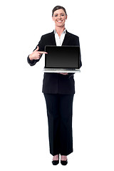 Image showing Businesswoman presenting new laptop