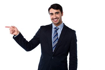 Image showing Smart businessman pointing at something