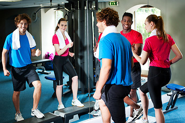 Image showing Couple with personal fitness trainer in the gym