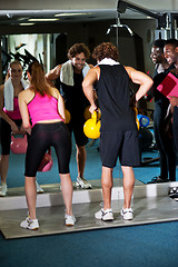 Image showing Fitness trainer giving out instructions to people