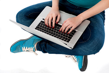 Image showing Cropped image of a girl working on laptop