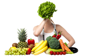 Image showing Beautiful woman hiding her face with spinach