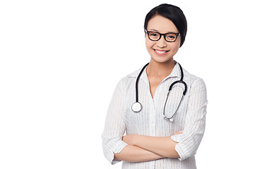 Image showing Young pretty female doctor with arms folded