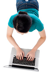 Image showing Aerial shot of a girl working on laptop