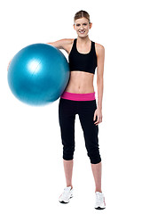 Image showing Female fitness trainer holding aerobic ball